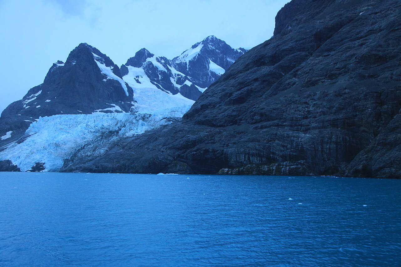 Glacier and jagged peaks above the water at Drygalski Fjord, South Georgia